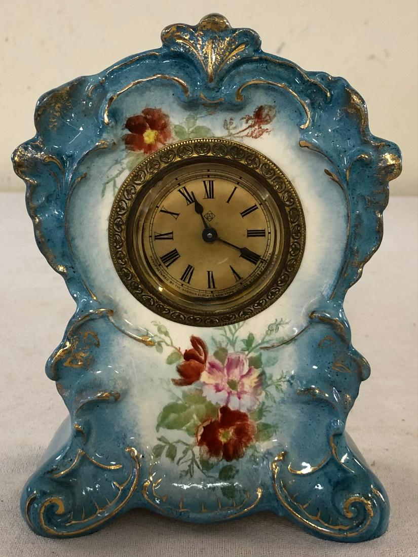 MINIATURE GERMAN ROYAL BONN PORCELAIN SHELF CLOCK: GERMAN ROYAL BONN CLOCK MARKED ON BACK WITH ROYAL BONN LOGO - IMPRESSED #2644 - BLUE WITH GILT HIGHLIGHTS AND FLORAL DECORATION - WORKING WHEN TESTED - ONE TINY 'FLEA BITE' ON BASE OF REAR RIGHT FOOT.