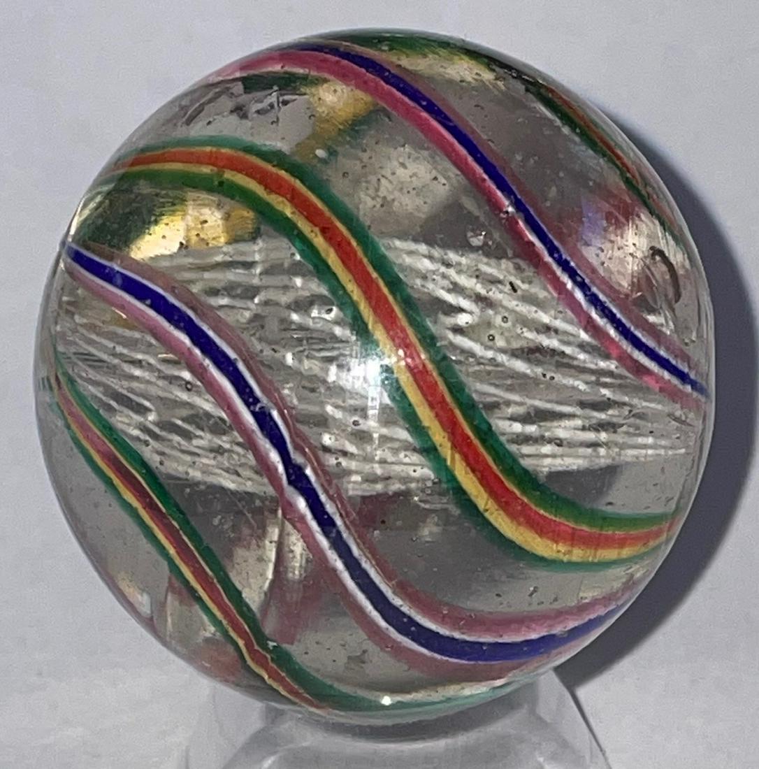 1 5/8" + ANTIQUE GERMAN SWIRL LATTICINIO CORE MARBLE: 1 5/8" + ANTIQUE GERMAN SWIRL LATTICINIO CORE MARBLE WITH WHITE LATTICINIO CORE WITH RED, WHITE, BLUE AND GREEN, RED, YELLOW ALTERNATING SWIRLS - MINOR SURFACE WEARâ€¦SEE PHOTOS
