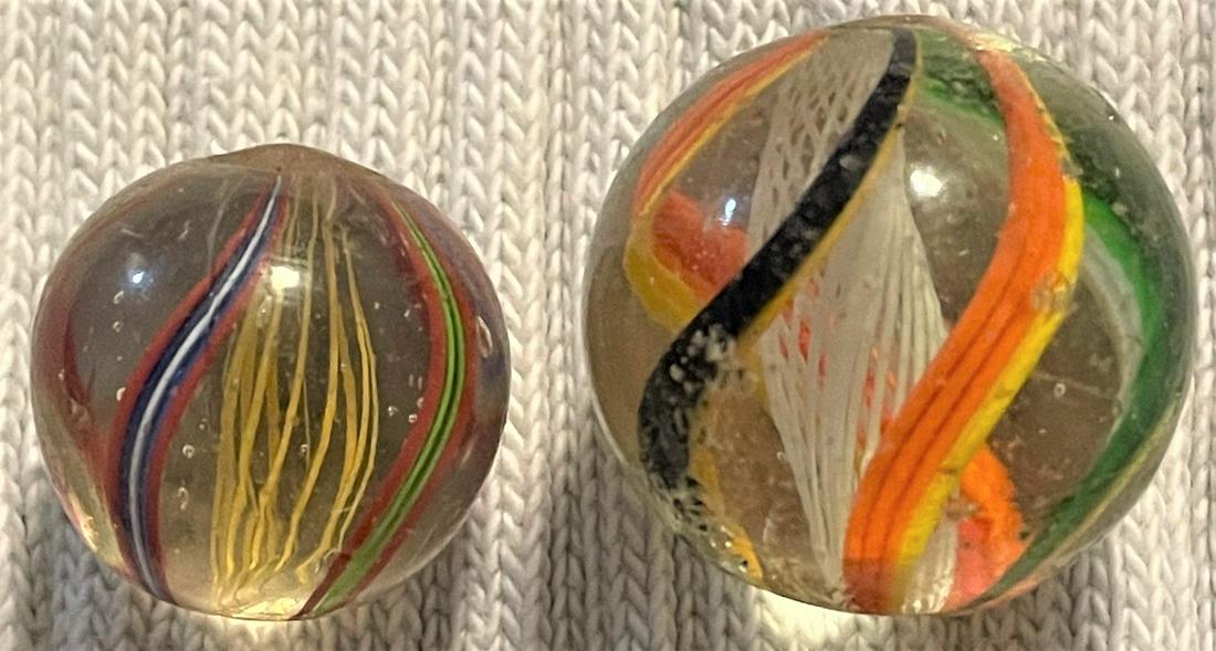 LOT 2 ANTIQUE GERMAN SWIRL LATTICINIO CORE MARBLES: LOT 2 ANTIQUE GERMAN SWIRL LATTICINIO CORE MARBLES - #1 15/16" WHITE LATTICINIO CORE WITH ORANGE & YELLOW, GREEN & YELLOW AND BLACK & YELLOW OUTER SWIRLS - SURFACE WEAR - #2 3/4" YELLOW LATTICINIO COR