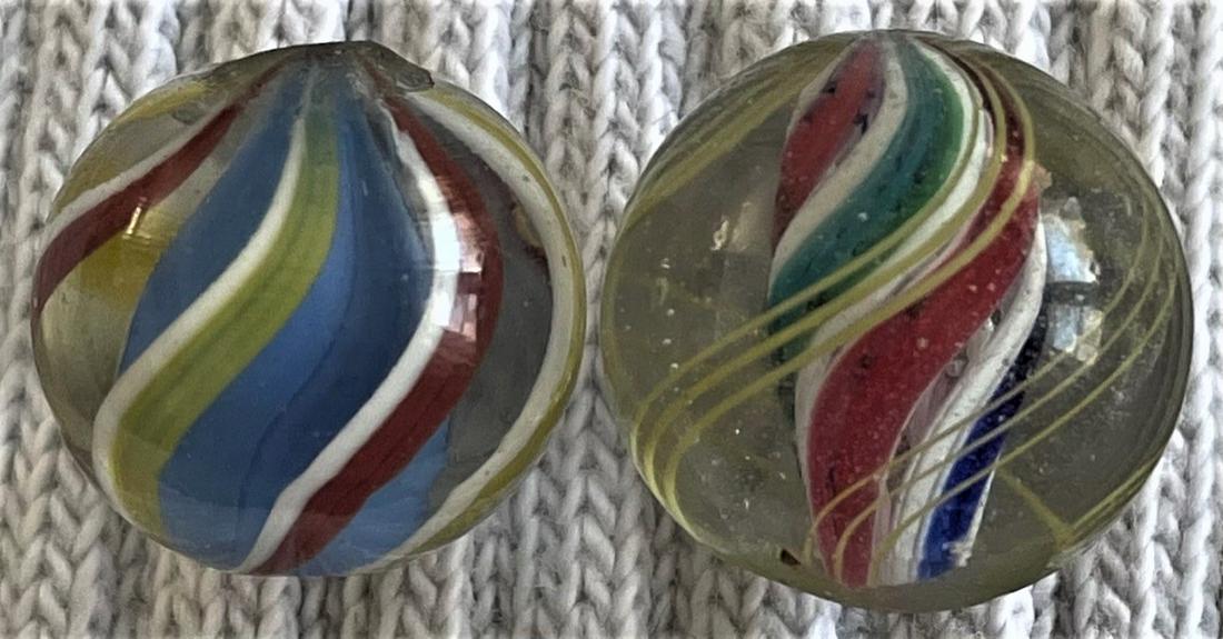 LOT 2 ANTIQUE GERMAN SOLID CORE MARBLES: LOT 2 ANTIQUE GERMAN SOLID CORE MARBLES - 1. 19/32" SOLID BLUE CORE SURROUNDED BY ALTERNATING RED & WHITE AND YELLOW & WHITE SWIRLS - 2. 5/8" VERY FINE / TIGHT RED, WHITE, BLUE & GREEN RIBBON CORE WIT