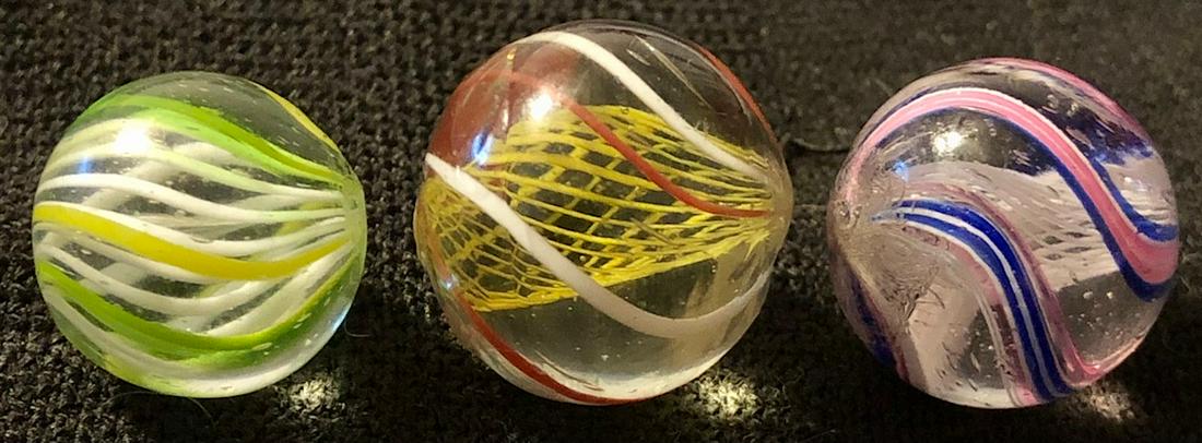 LOT 3 GERMAN LATTICINIO CORE SWIRL MARBLES: LOT 3 GERMAN LATTICINIO CORE SWIRL MARBLES - 1. 9/16" WHITE LATTICINIO CORE WITH YELLOW, GREEN & BLACK OUTER SWIRLS - 2. 5/8" WHITE LATTICINIO CORE WITH WITH RED, WHITE & BLUE OUTER SWIRLS - 3. 11/16"