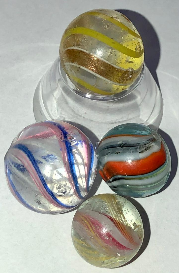 LOT 4 ANTIQUE GERMAN SWIRL / LUTZ MARBLES: LOT 4 ANTIQUE GERMAN SWIRL MARBLES INCLUDING A LUTZ - THE LUTZ SWIRL MARBLE HAS YELLOW SWIRLS AND 2 LUTZ SWIRLS OUTLINED IN WHITE SWIRLS - SURFACE WEAR TO ALL 4 MARBLES - 1/2" - 3/4"