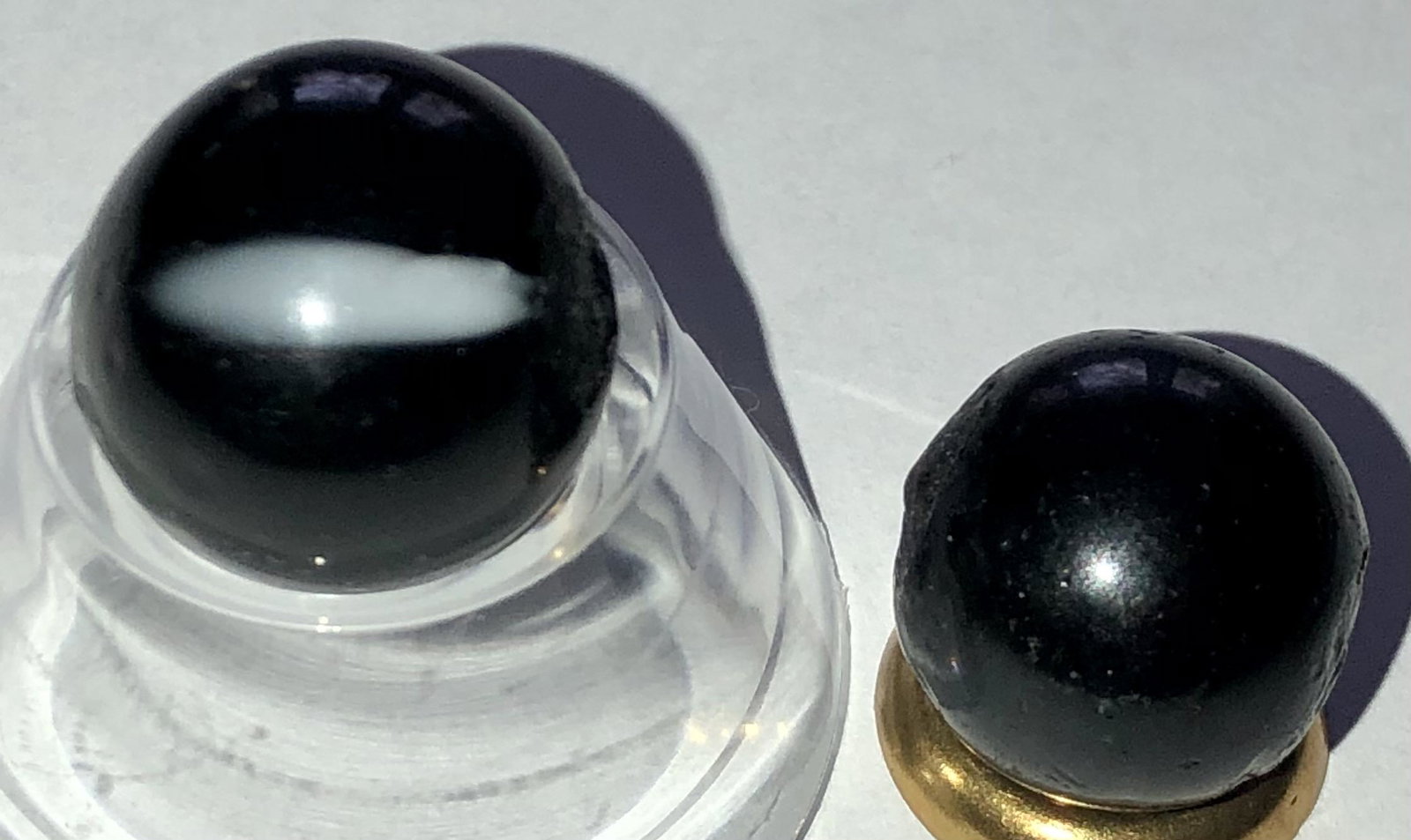 LOT 2 ANTIQUE GERMAN BLACK INDIAN MARBLES: LOT 2 ANTIQUE GERMAN BLACK INDIAN MARBLES WITH PONTILS - LARGER ONE WITH WHITE MARKINGS - VERY GOOD CONDITION - 17/32" - 9/16"