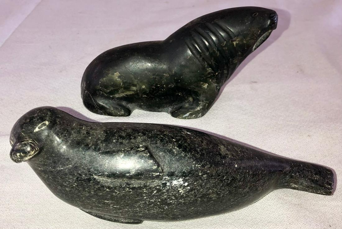 LOT 2 INUIT CARVED CANADIAN STONE CARVINGS: LOT 2 INUIT CARVED CANADIAN STONE CARVINGS WITH ORIGINAL LABELS ON BOTTOMS, AS WELL AS OTHER MARKINGS - SEA LION 6" X 2" WIDE X 3 3/8" HIGH, SEAL 7 1/2" X 1 5/8" WIDE X 2 3/8" HIGH - VERY GOOD CONDITI