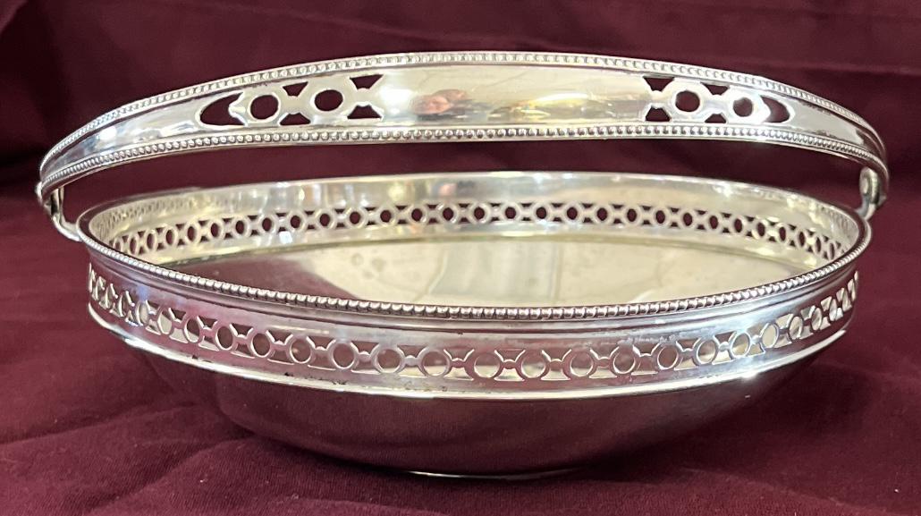 .800 SILVER HANDLED DISH: .800 SILVER HANDLED DISH WITH RETICULATED PIERCE DECORATED SIDE BAND, BEADED TOP RIM - HINGED BAIL HANDLE WITH BEADED EDGES AND PIERCED DECORATION - STAMPED .800 & MAKERS MARK - 6" DIAMETER, 5" HIGH T