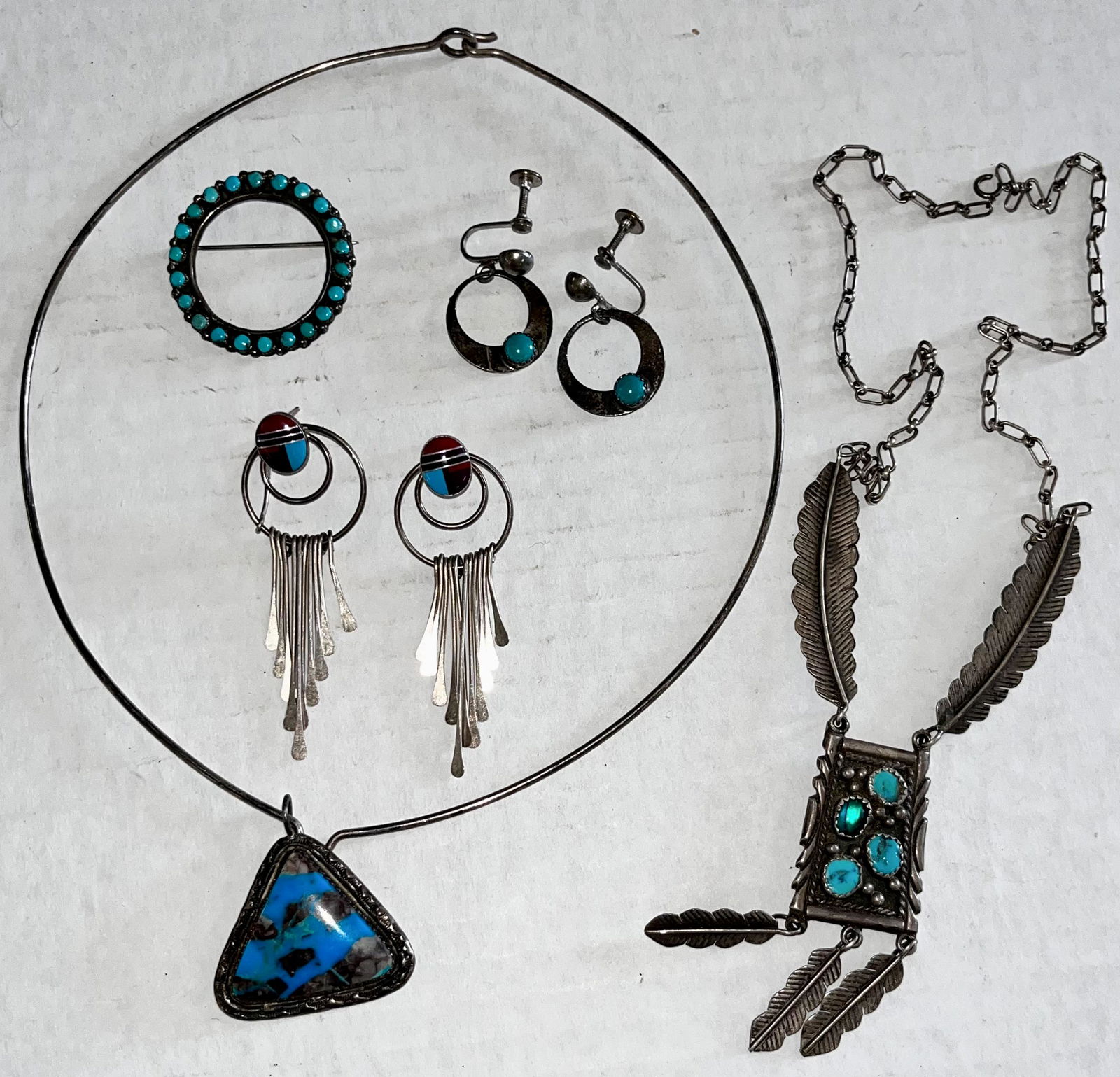 7 PIECE LOT NATIVE AMERICAN JEWELRY: 7 PIECE LOT NATIVE AMERICAN STERLING SILVER AND TURQUOISE JEWELRY INCLUDING 2 NECKLACES, 2 PR. EARRINGS AND A BROOCH / PIN - THE FEATHER NECKLACE IS SIGNED "S.A. ARVISO" - GOOD OVERALL CONDITION - FEA