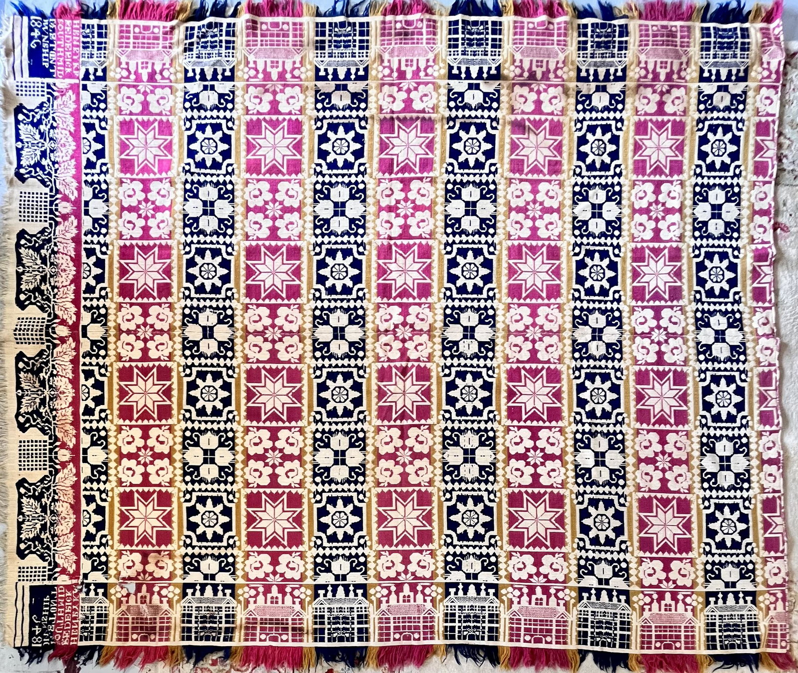 19TH C. RED, WHITE & BLUE COVERLET "HENRY K. FREDERICK 1846": 19TH C. RED, WHITE, BLUE & GOLD COVERLET WITH BUILDINGS, FLOWERS, ETC. "HENRY K. FREDERICK / MIDELETON TOWNSHIP 1846" - 93" X 75"