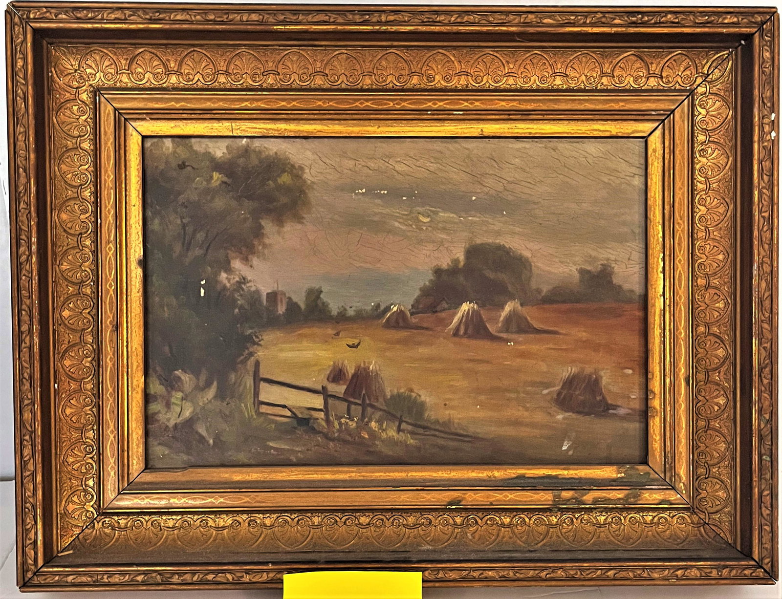 19TH C. FRAMED O/C LANDSCAPE PAINTING WITH HAY STACKS: 19TH C. FRAMED O/C LANDSCAPE PAINTING WITH HAY STACKS IN ORNATE GILT FRAME - MINOR LOSSES, NEEDS CLEANING - FRAME 16 3/4" X 12 3/4", SIGHT 11 5/8" X 7 5/8"
