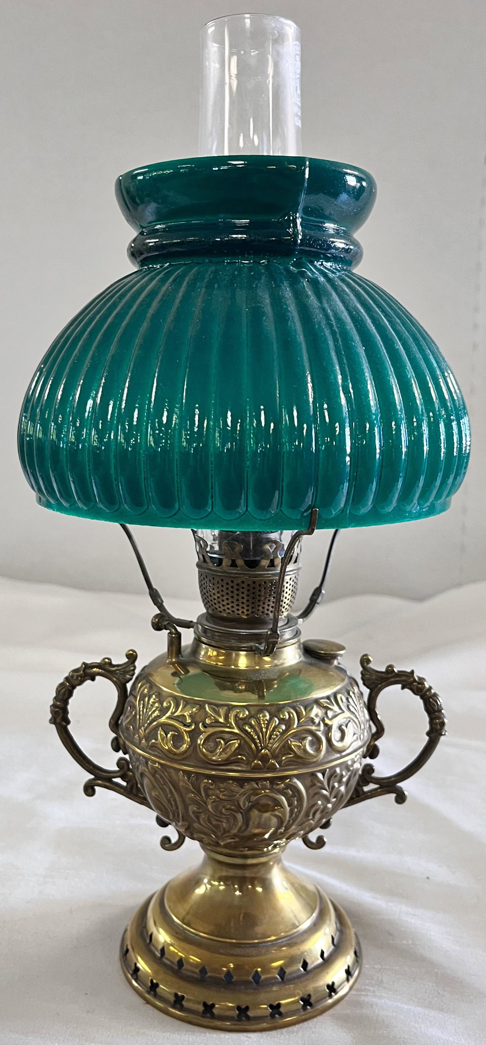MINIATURE VICTORIAN EMBOSSED BRASS OIL LAMP W/ SHADE: MINIATURE VICTORIAN EMBOSSED BRASS OIL LAMP W/ SHADE - CAST BRASS SIDE HANDLES - SIGNED CHIMNEY "KEYSTONE BEST LEAD GLASS" - GOOD OVERALL CONDITION - 13 1/2" HIGH, 3 3/4" DIAMETER FONT