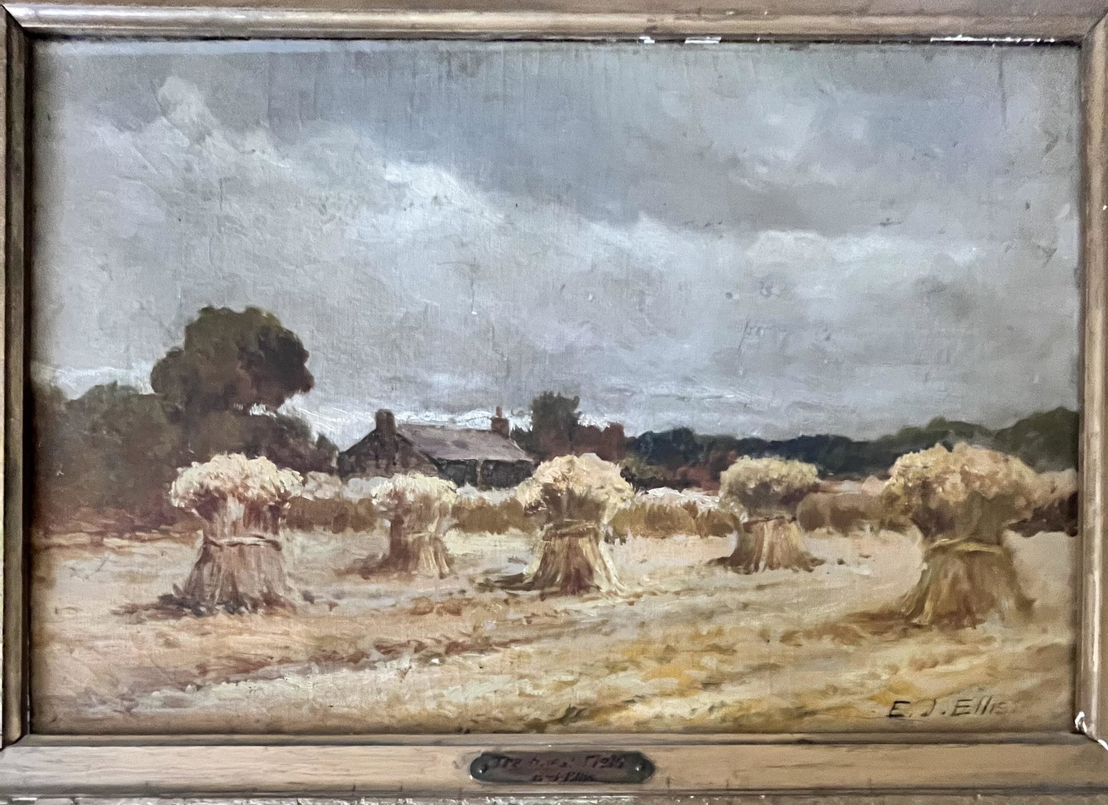 ANTIQUE O/C LANDSCAPE "THE WHEAT FIELD" PAINTING SIGNED: ANTIQUE OIL ON CANVAS LANDSCAPE PAINTING TITLED "THE WHEAT FIELD" BY E.J. ELLIS - SIGNED LOWER RIGHT "E.J. ELLIS" - BRASS PLATE ATTACHED TO FRAME - 22 1/2" X 16 1/2", SIGHT 17 1/2" X 11 1/2" - CONDITI
