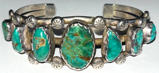 NATIVE AMERICAN STERLING & TURQUOISE CUFF BRACELET: NATIVE AMERICAN STERLING & TURQUOISE CUFF BRACELET - 7 GRADUATED SIZE NATURAL TURQUOISE STONES - 3/4" X 1/2" LARGEST CENTER STONE - STAMPED "STERLING" AND STAMPED MAKERS MARK "BB" - 40.21 TOTAL GRAMS