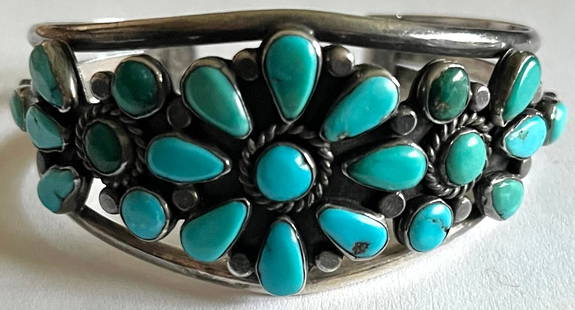 NATIVE AMERICAN STERLING & TURQUOISE CUFF BRACELET: NATIVE AMERICAN STERLING & TURQUOISE CUFF BRACELET - 23 TEAR DROP & ROUND TURQUOISE STONES IN A FLORAL DESIGN - TEAR DROP SHAPED STONES MEASURE 5/16" X 3/16" - 36.47 TOTAL GRAMS