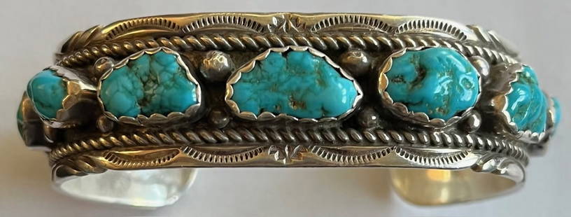 NATIVE AMERICAN STERLING & TURQUOISE CUFF BRACELET: NATIVE AMERICAN STERLING & TURQUOISE CUFF BRACELET - 9 NATURAL TURQUOISE STONES - STONES MEASURE FROM 3/8" TO 5/8" - 42.67 GRAMS - OUTDSIDE MEASUREMENT 7 1/4", INTERIOR MEAUSUREMENT 5 3/4"