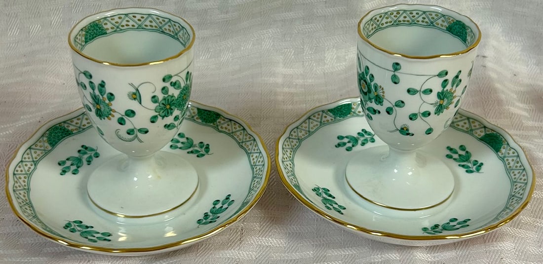 PR. MEISSEN PORCELAIN EGG CUPS / CROSSED SWORD MARK: PR. MEISSEN PORCELAIN EGG CUPS WITH ATTACHED 'SAUCERS' - WHITE PORCELAIN WITH GREEN & YELLOW PAINTED FLORAL DECORATION - BOTH CROSSED SWORD MARK AND IMPRESSED NUMBERS - GOOD CONDITION - NO CHIPS, CRAC