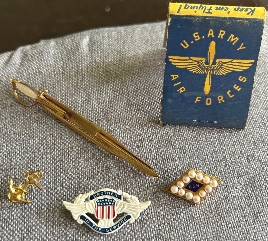 LOT OF 5 U.S. MILITARY RELATED ITEMS: LOT OF 5 U.S. MILITARY RELATED ITEMS - U.S. ARMY AIR FORCES MATCH BOOK, WWI / WWII "BROTHER IN SERVICE" PIN, SMALL NAVAL ACADEMY ANCHOR PIN, "SWANK" SWORD TIE CLIP / BAR, SMALL USN PIN