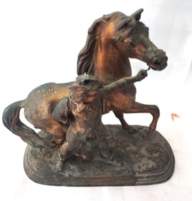 Antique Metal figure holding the rains of a horse