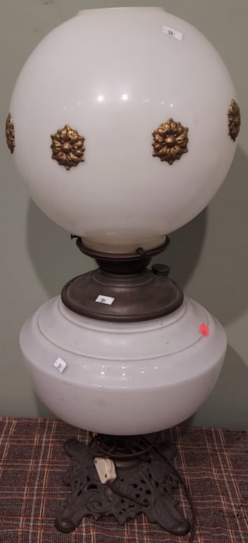 Electrified Antique Oil Lamp with Milk Glass Shade with Brass Rosettes: Electrified Antique Oil Lamp with Milk Glass Shade with Brass Rosettes, Cast iron base - Measures approx. 25" high to top of shade - Condition as pictured, unless otherwise noted. If you have any ques