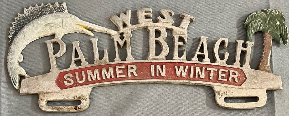 Vintage West Palm Beach Florida Cast Aluminum License Plate Topper, "Summer in Winter": a charming and rare vintage cast aluminum license plate topper from West Palm Beach, Florida. Featuring vibrant hand-painted details including a leaping marlin and a palm tree, this mid-century topper