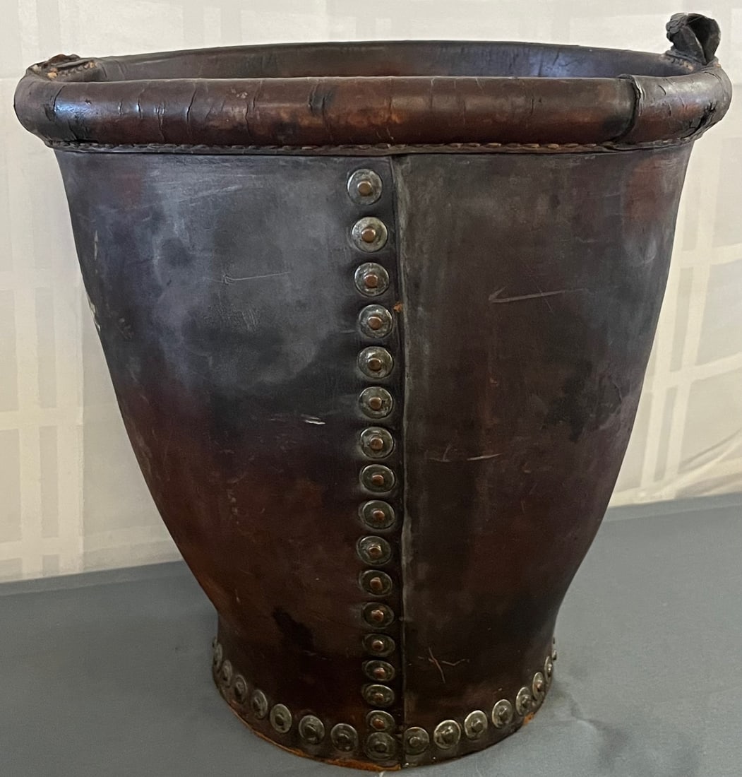 19th C. English leather fire bucket secured with copper rivets: 19th C. English leather fire bucket secured with copper rivets, missing handle, measures approx. 11 1/2' high, 10 1/2" in diameter, condition as seen in photos provided