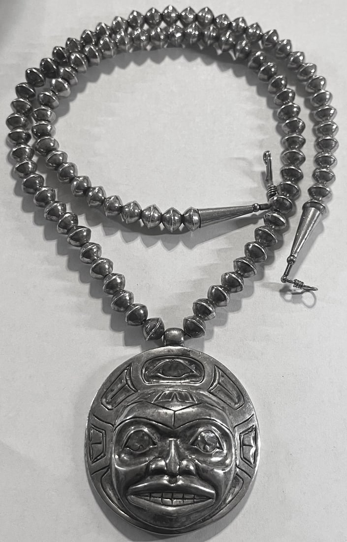 1977 Patty Fawn Kwakiutl sterling silver Spirit Mask Pendant necklace with light blue stones, 157g: A captivating heavy sterling silver pendant necklace designed and signed by Patty Fawn, signed on the reverse "5-25 / Patty Fawn / 1977". The large sculptural pendant depicts a stylized ceremonial or 