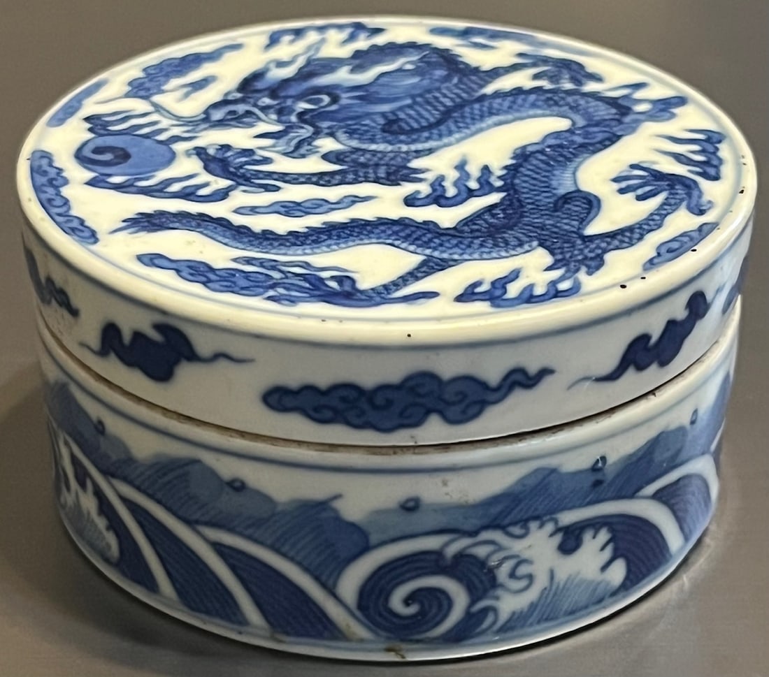 Fine Chinese Blue & White Porcelain Covered Box with Imperial Dragon: A finely painted Chinese porcelain circular lidded box featuring a five-clawed Imperial Dragon amid clouds, chasing a flaming pearl on the lid. The sides are decorated with crashing waves and stylized