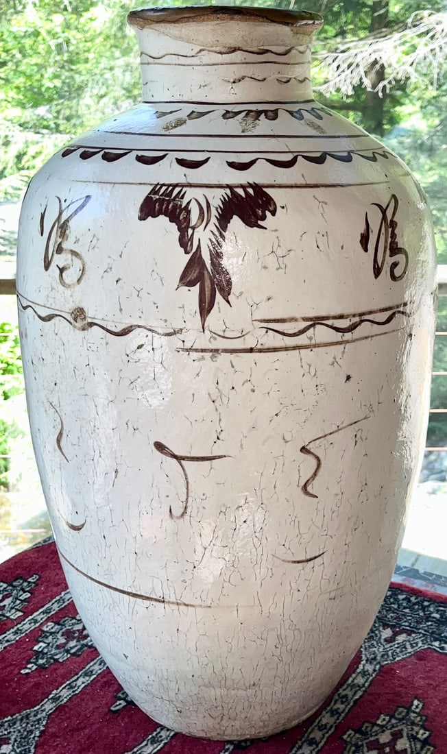 A Large Monumental Chinese Ming Cizhou Stoneware Wine Jar with White Slip Glaze: A Large Monumental Chinese Ming Cizhou Stoneware Wine Jar with White Slip decoration and bold iron-oxide brushwork with birds in flight and abstract calligraphy. The ovoid body tapers to a thick foot