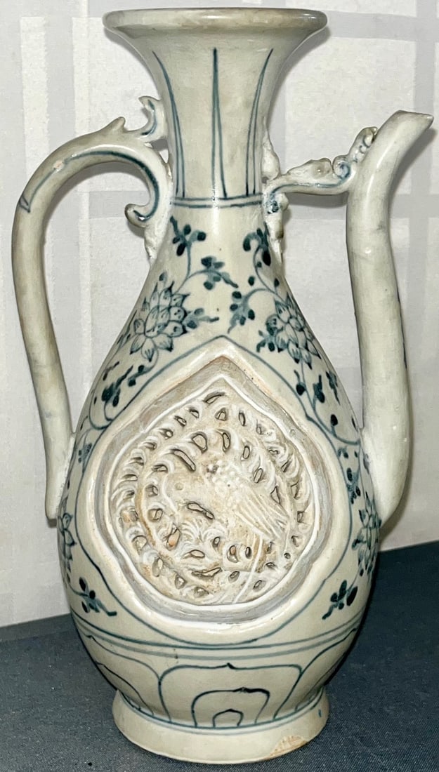 Annamese / Vietnamese Blue and White Ceramic Ewer, Ly or Tran Dynasty Influence: Vietnamese Porcelain Ewer with molded, pierced bird medllions in relief, on both sides, and delicate floral underglaze blue decoration, dual draon / serpent-inspired handle and spout and a flattened c