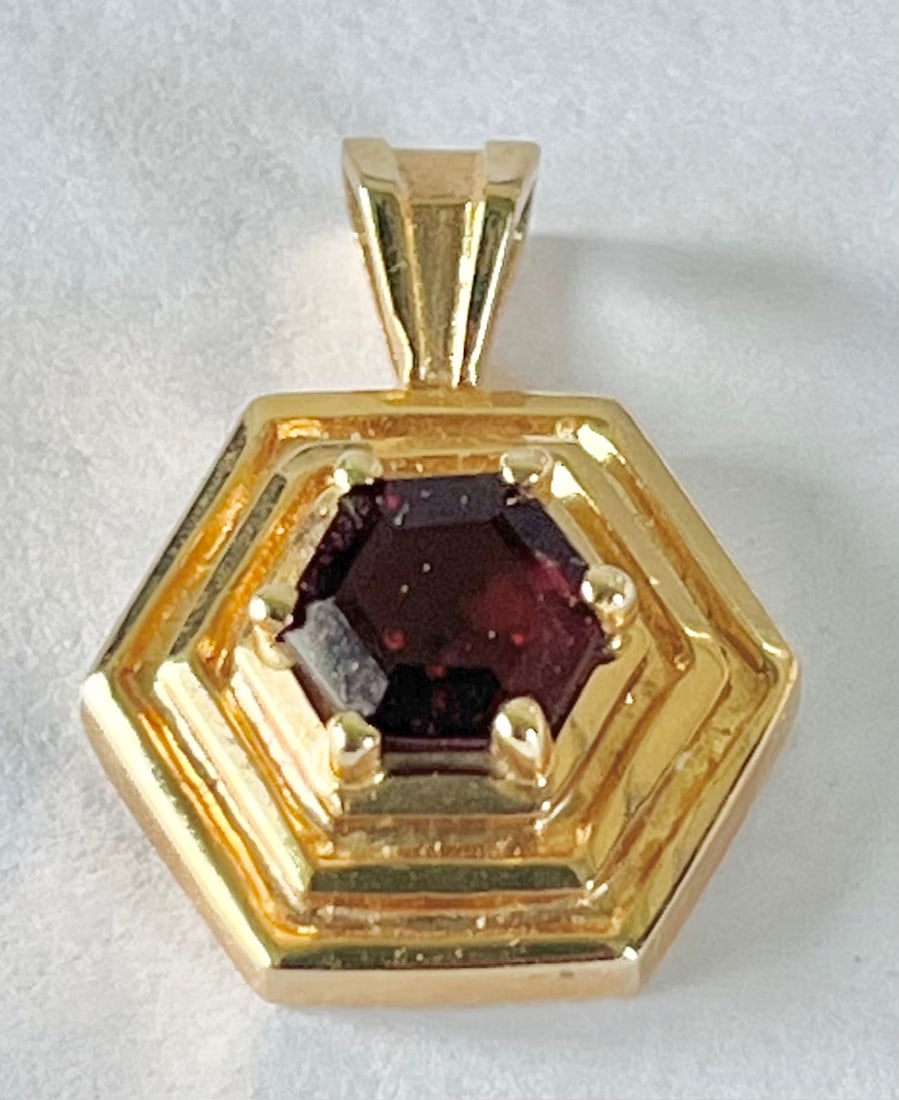 10K Yellow Gold & Hexagonal Garnet Pendant, 3/4" H, 3.1 Grams: 10K Yellow Gold Hexagonal shaped Pendant with a single Hexagonal shaped cut Garnet, 3/4" H, 3.1 Grams, condition as seen in photos provided