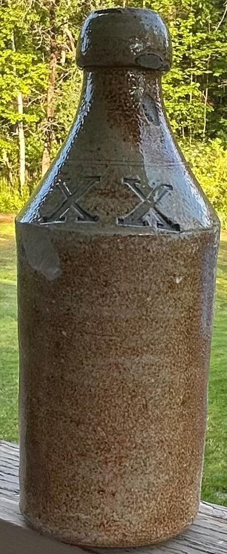 19th C. Stoneware Bottle with Impressed "XX" In Blue: 19th C. Stoneware Bottle with Impressed "XX" In Blue, measures approx. 9 1/2" high, 3 1/2" diameter, condition as seen in photos provided