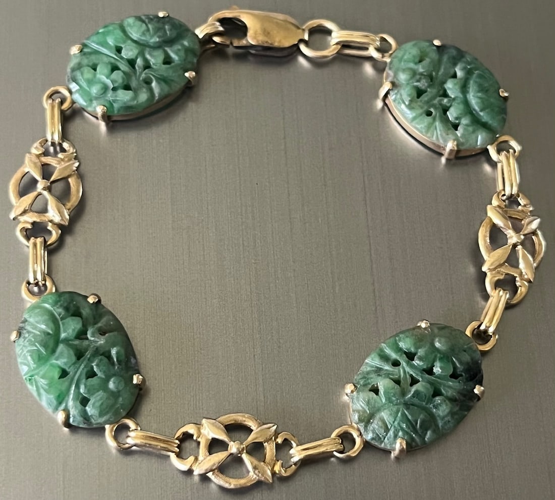Vintage 14K Yellow Gold and Carved Green Jade Bracelet: Vintage 14K Yellow Gold and Carved Green Jade Bracelet featuring five hand-carved oval jade panels in the form of stylized scarabs or floral motifs. The vivid green jadeite stones exhibit natural mott