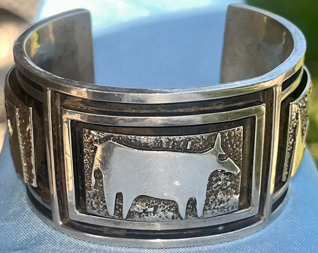 Bold Navajo Native American Sterling Silver Cuff Bracelet, Darryl Dean Begay, 142 grams: Handcrafted by acclaimed Navajo silversmith Darryl Dean Begay, this substantial sterling silver cuff bracelet features raised overlay designs of a longhorn steer and stylized lightning or mountains. T