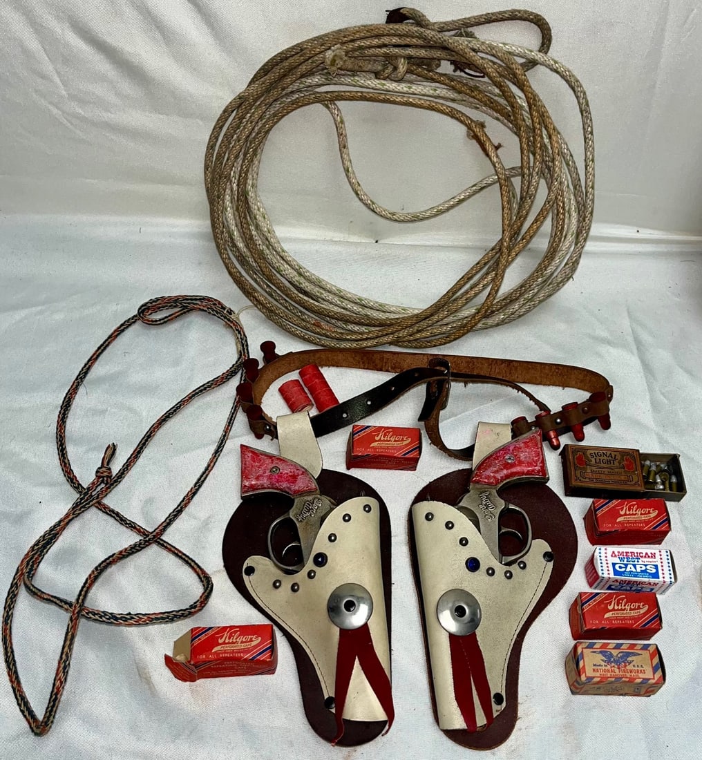 1950s Gene Autry Twin Cap Gun & Holster Set with Lariat, Ammunition Boxes & Accessories: 1950s Gene Autry Twin Cap Gun & Holster Set with Lariat, Ammunition Boxes & Accessories, A vintage 1950s Gene Autry cowboy play set featuring a matched pair of Gene Autry–branded die-cast cap guns,