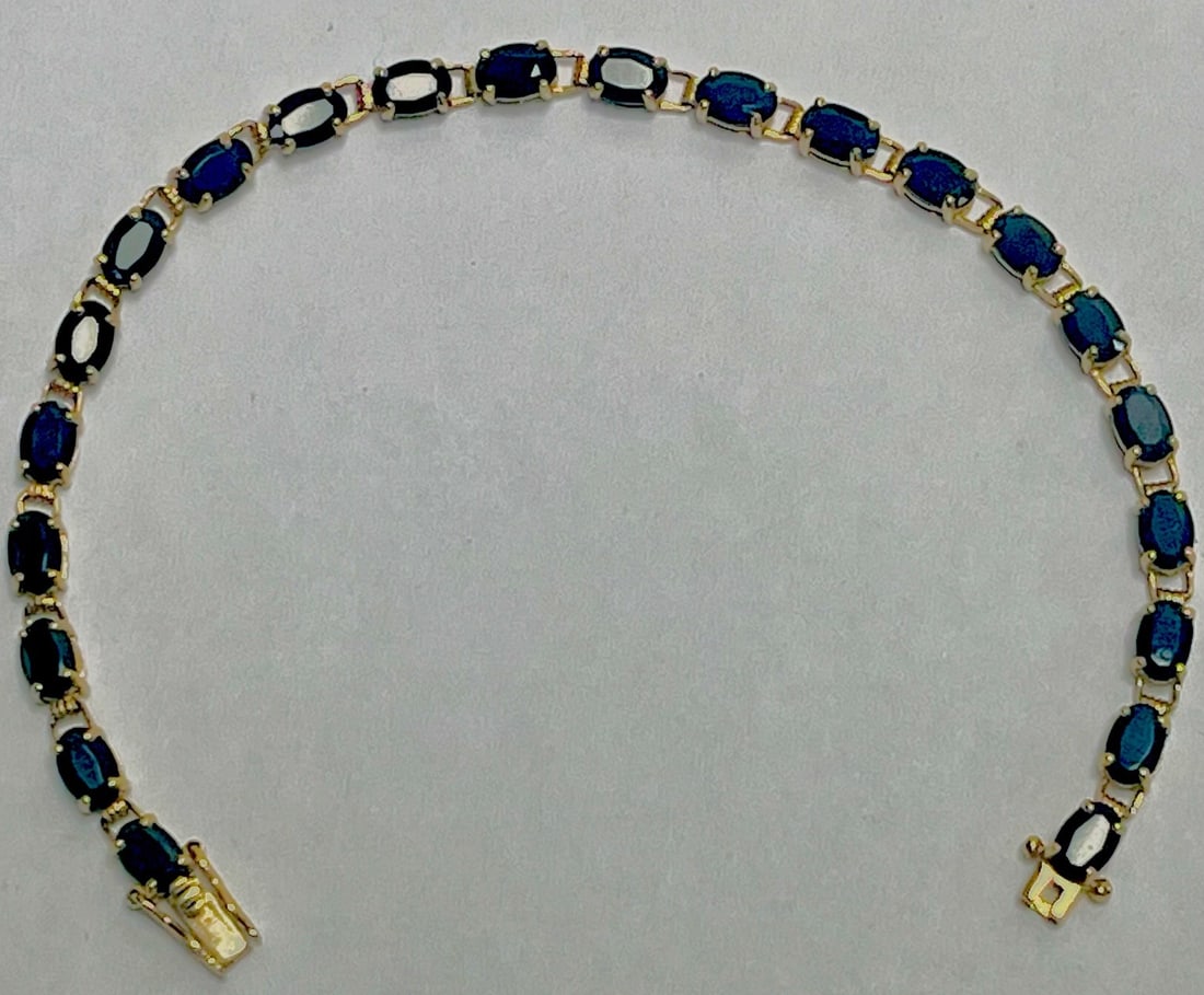 10K Yellow Gold Oval Blue Sapphire Tennis Bracelet, 6.44 grams, 7 1/4" long: 10K Yellow Gold Oval Blue Sapphire Tennis Bracelet, 6.44 grams, 7 1/4", Elegant 10K yellow gold line bracelet set with a continuous row of oval-cut deep blue sapphires in open-back four-prong mounts.