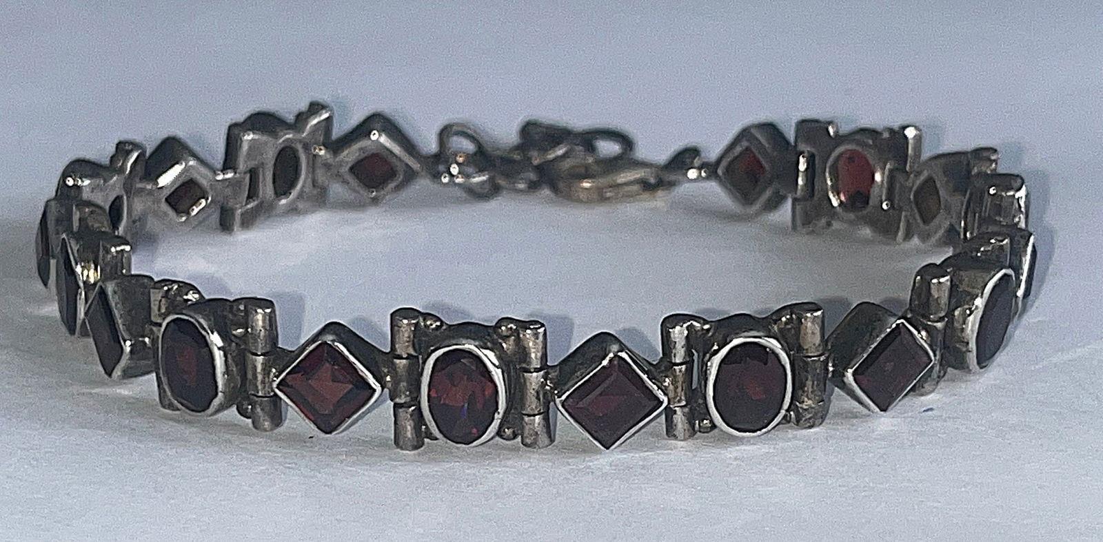 Vintage Sterling Silver & Garnet Geometric Link Bracelet, 8" Long, 18.72 Grams: Vintage Sterling Silver & Garnet Geometric Link Bracelet, 8" Long, 18.72 Grams, Vintage link bracelet in sterling silver set with deep wine-red faceted stones, consistent with garnet. The bracelet is