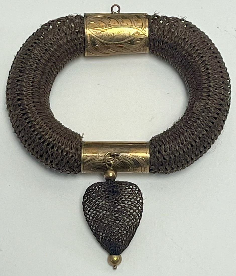 Victorian Mourning Hairwork Bracelet with Gold-Filled Mounts and Heart Pendant, c. 1860–1880: Victorian Mourning Hairwork Bracelet with Gold-Filled Mounts and Heart Pendant, c. 1860–1880, Victorian-era mourning bracelet composed of finely woven human hair, formed as a substantial circular ba