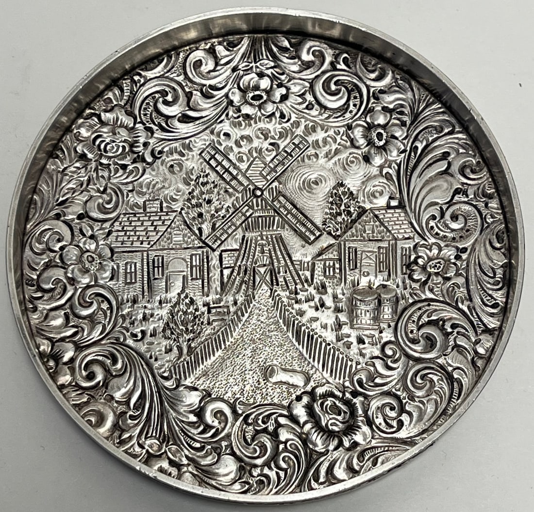 Dutch Sterling Silver Repoussé Wine Bottle Coaster with Windmill & Village Scene, 19th Century: Dutch Sterling Silver Repoussé Wine Bottle Coaster with Windmill & Village Scene, 19th Century, WEIGHS APPROX. 98 GRAMS / 3.15 TROY OUNCES / 63 DWT (PENNY WEIGHT), MEASURES APPROX. 4 1/4" DIAMETE