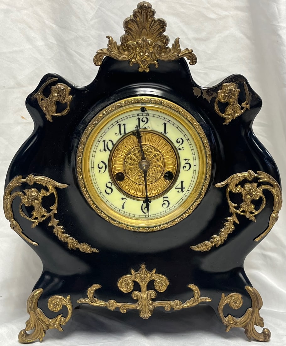 Antique Waterbury Cast Iron Shelf / Mantel Clock – Black Ebonized Case with Gilt Ormolu Mounts: Antique Waterbury Cast Iron Shelf / Mantel Clock – Black Ebonized Case with Gilt Ormolu Mounts – c.1898, Late 19th-century Waterbury Clock Company mantel or shelf clock, featuring a dramat