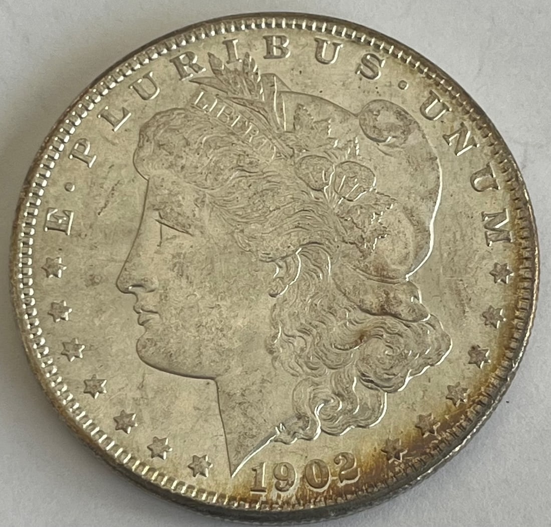 1902-O Morgan Silver Dollar – New Orleans Mint – 90% U.S. Silver Coin: 1902-O Morgan Silver Dollar – New Orleans Mint – 90% U.S. Silver Coin, Original 1902-O Morgan Silver Dollar struck at the New Orleans Mint. The obverse features Liberty wearing a Phrygian