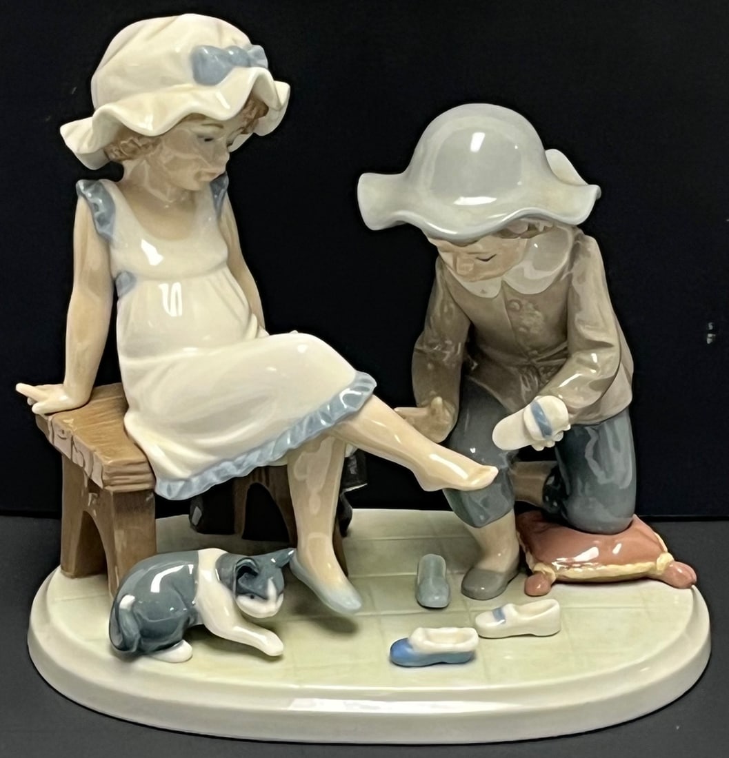 Lladro “Shoe Shine” Figurine #5223 – Boy Polishing Girl’s Shoe w/ Dog –: Lladro “Shoe Shine” Figurine #5223 – Boy Polishing Girl’s Shoe w/ Dog – Spain Porcelain, Charming vintage Lladro porcelain figurine depicting a young boy polishing a girl