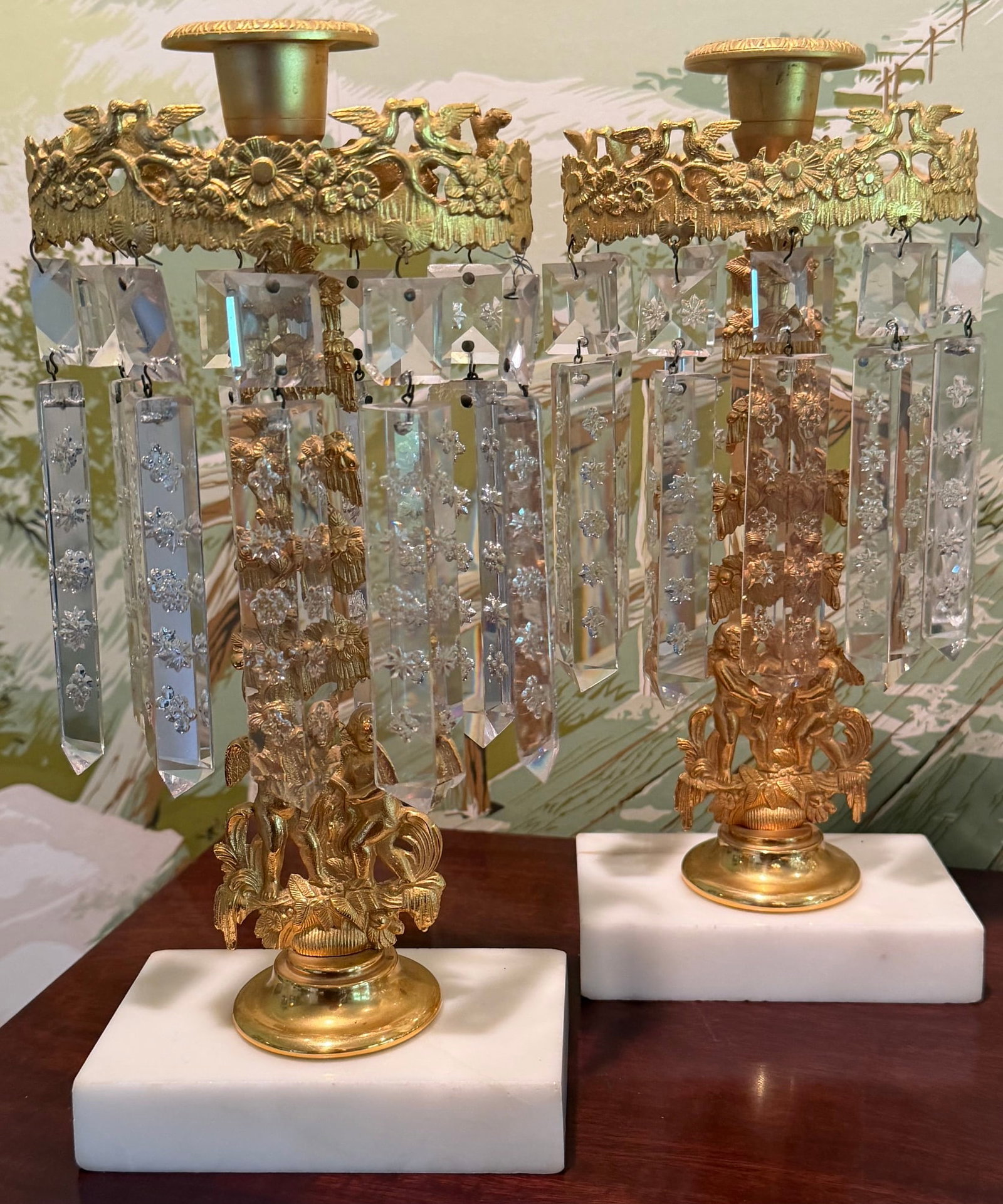 Pair 19th C. Gilt Brass Figural Girandole Candlesticks with Cut Crystal Prisms: Elaborate pair of antique gilt brass figural girandole candlesticks, likely dating to the mid-19th century, circa 1840–1870. Each single-light girandole is richly decorated with a pastoral figural g