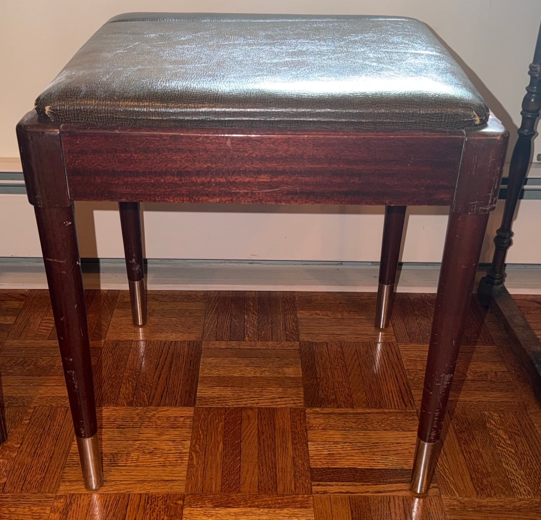 Mid-Century Modern Mahogany Vanity / Sewing Bench / Piano Stool with Storage: Mid-century modern upholstered vanity, Sewing or piano bench, circa 1950s–1960s. Rectangular mahogany-finished wood frame raised on four tapered legs terminating in contrasting metal sabots. Hinged 