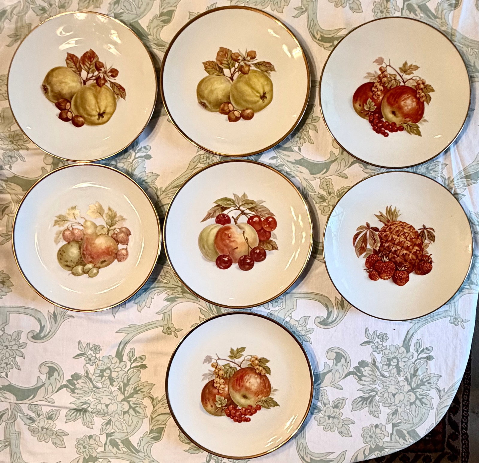 Group of 7 Bareuther Waldsassen Bavaria Porcelain Fruit Plates: Group of seven vintage German porcelain dessert or luncheon plates by Bareuther Waldsassen, Bavaria. Each white porcelain plate is decorated with a colorful central still-life arrangement of fruit, in