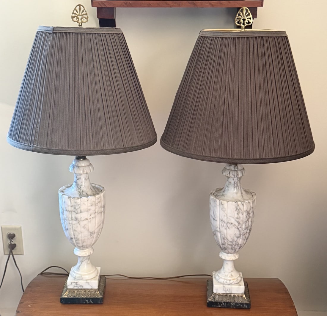 Pair Neoclassical Carved White Marble Urn Table Lamps: Elegant pair of Neoclassical-style table lamps, each featuring a substantial carved white marble urn-form body with natural gray veining. The elongated bodies are deeply fluted and raised on turned