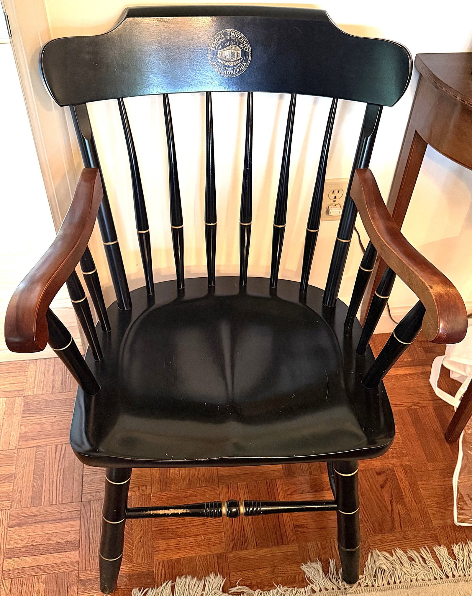 Temple University Philadelphia Captain’s Armchair: Temple University commemorative captain’s armchair, constructed in wood with a black painted finish and contrasting warm brown shaped armrests. The broad crest rail bears the Temple University, Phil