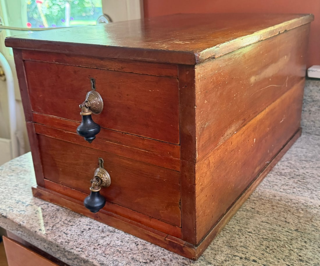 19th C. American Two-Drawer Cherry Document / Collector’s Chest: Antique American two-drawer tabletop chest, dating to the mid-to-late 19th century, constructed in warm reddish-brown hardwood (Cherry) Rectangular case with projecting molded top and base, fitted