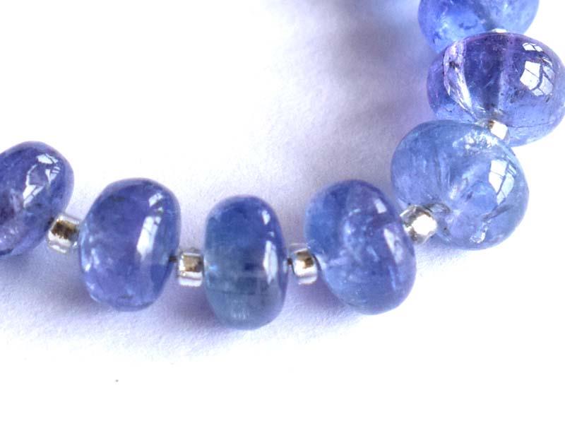 FINE TANZANITE BEADS - RONDELLE 5 - 6 mm: " TASSEL"- means the drilled pieces of gemstones are loosely attached with a wire , ideally you can use it to create of of a kind jewelry . STONE : NATURAL EARTH MINED FINE QUALITY OF TANZANITE BEADS 