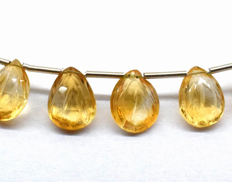 CITRINE CARVED PEAR SHAPE BRIOLETTES - TASSEL: " TASSEL"- means the drilled pieces of gemstones are loosely attached with a wire , ideally you can use it to create of of a kind jewelry . STONE : NATURAL GEMSTONE CITRINE FACETED CARVED BRIOLETTE BE