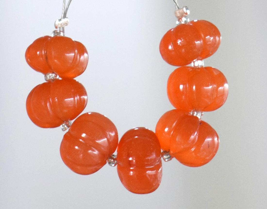 CARNELIAN - RONDELLE 8.5 - 9 mm - TASSEL: " TASSEL"- means the drilled pieces of gemstones are loosely attached with a wire , ideally you can use it to create of of a kind jewelry . STONE : NATURAL EARTH MINED FINE CARNELIAN MELON CARVED ROND
