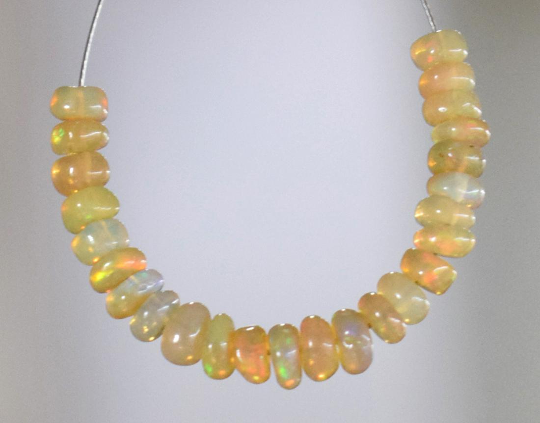 ETHIOPIAN OPAL - RONDELLE 3.5 mm - TASSEL: " TASSEL"- means the drilled pieces of gemstones are loosely attached with a wire , ideally you can use it to create of of a kind jewelry . STONE : NATURAL EARTH MINED FINE ETHIOPIAN OPAL RONDELLE SHA