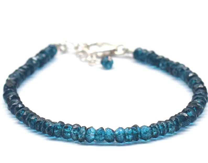 LONDON BLUE TOPAZ BRACELET W/ 925 SILVER: These are Natural , earth mined LONDON BLUE TOPAZ (COATED) faceted rondelle shape beads finished with SOLID 925 Sterling Silver lobster clasp. All chains and spacers are also Solid 925 Sterling Silver